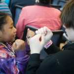 Photo by Rashah McChesney/Peninsula Clarion  Madison Reams, 9, plays with her brother Enoch Reams, 18, during the grand opening ceremony of the Kenaitze Indian Tribe's Dena'ina Wellness Center Thursday June 12, 2014 in Kenai, Alaska.
