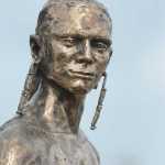 Photo by Rashah McChesney/Peninsula Clarion  A bronze statue of a Dena'ina fisherman, crafted by Soldotna-native Joel Isaak, was unveiled outside of the Kenaitze Indian Tribe's Dena'ina Wellness Center Friday June 13, 2014 in Kenai, Alaska.