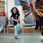 Photo by Rashah McChesney/Peninsula Clarion Cadence Fischer, 8, laughs as her younger sister Isis Fischer, 6, reacts to being allowed to dance during the grand opening ceremony for the Dena'ina Wellness Center Friday June 13, 2014 in Kenai, Alaska.