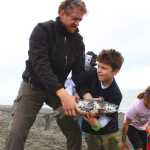 Photo by Kelly Sullivan/ Peninsula Clarion Community members of all ages helped pull in the setnet at the end of the three-day celebration for the opening of the Dena'ina Wellness Center, Saturday, at the Kenaitze educational fishery site.