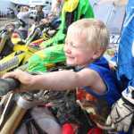 Photo by Kelly Sullivan/ Peninsula Clarion Chase Anderson sits on the bike in front of his brother, both part of the large group or riders Team Valley Rally from Mat-Su, Saturday, at Twin City Raceway.