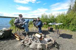 Photo by Rashah McChesney/Peninsula Clarion  Jon Preston and Norvell Robertson relax by Peterson Lake in the Kenai National Wildlife Refuge Wednesday June 18, 2014 near mile 68.3 of the Sterling Highway. Preston had been fishing for rainbow trout earlier in the day but said it was too windy to be successful.