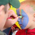 Photo by Kelly Sullivan/Peninsula Clarion Ben Jennings chose to have his face painted blue and green at the Frontier Community Services World Series Baseball event, Saturday, June 22.