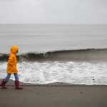 Photo by Rashah McChesney/Peninsula Clarion Several people piled onto a four-wheeler and passed off a family dog to Becky and Jonathan Peters during a beachwalk to raise funds for Arctic Barnabas Ministries Saturday June 21, 2014 in Kenai, Alaska. Jonathan Peters, executive director of Arctic Barnabas said the group raised more than $13,000 for their aviation-based ministry.