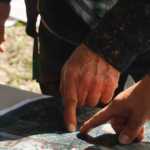Photo by Rashah McChesney/Peninsula Clarion Volunteers discuss locations on a map where a community search has been started for a missing Kenai family Tuesday June 24, 2014 in Kenai, Alaska.
