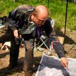 Photo by Rashah McChesney/Peninsula Clarion Matt Schilf, of Kenai, points to a spot on a large map of a portion of Kenai near the home of a missing Kenai family Tuesday June 24, 2014 in Kenai, Alaska.  Schilf and 14 others spent the bulk of the day searching in the woods for signs of the family.