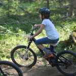 Photo by Rashah McChesney/Peninsula Clarion Lexi Larson eases her way down a banked turn on the new Moosequito Trail singletrack mountain biking trail Wednesday July 2, 2014 at the Tsalteshi Trails in Soldotna, Alaska.