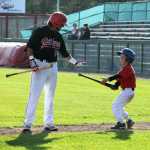 Photo by Dan Balmer/Peninsula Clarion Peninsula Oilers leadoff hitter Jake Sandlin hands a bat to the batboy in the fourth inning of Thursday's game against the Chugiak-Eagle River Chinooks at Coral Seymour Memorial Park.