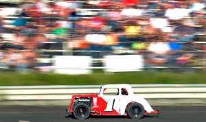 Photo by Rashah McChesney/Peninsula Clarion .... races past the crowd during a Legend car race Friday July 4, 2014 at the Twin Cities Raceway in Kenai, Alaska.