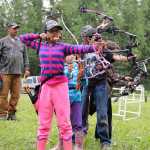 Photo by Dan Balmer/Peninsula Clarion Kira (front) and Lena Cook from Palmer try to be the first to hit an apple with their arrow during an archery shooting tournament at the Kenai Peninsula Archery Range Sunday in Soldotna. Kira placed second in the feamle cubs freestyle division.