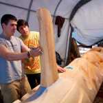 Haida carver TJ Young works with apprentice Jerrod Galanin on the Eagle totem pole for the Gajaa Hít building on Thursday. TJ and his brother, Joe, have been working on two poles and a screen to replace the aging ones in front of the building. The project was organized through Sealaska Heritage Institute in conjunction with the Tlingit Haida Regional Housing Authority, who owns the building.