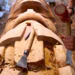 Haida carver TJ Young works on the Eagle totem pole for the Gajaa Hít building on Thursday. TJ and his brother, Joe, have been working on two poles and a screen to replace the aging ones in front of the building. The project has been organized through Sealaska Heritage Institute in conjunction with the Tlingit Haida Regional Housing Authority, who owns the building.