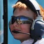 Photo by Kelly Sullivan/ Peninsula Clarion Lucas Cragg listens as pilot Alex Roesch coaches the Kenai Civil Air Patrol Cadet on handling the maintained World War II Advanced Trainer after takeoff, Saturday, at the Civil Air Patrol hanger.