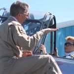 Photo by Kelly Sullivan/ Peninsula Clarion Lucas Cragg listens as pilot Alex Roesch coaches the Kenai Civil Air Patrol Cadet on handling the maintained World War II Advanced Trainer after takeoff, Saturday, at the Civil Air Patrol hanger.