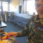 Photo by Kelly Sullivan/ Peninsula Clarion Kenai Civil Air Patrol Cadet Bradley Walters holds the photograph of the owner of the maintained World War II Advanced Trainer he flew in Saturday, at the Civil Air Patrol hanger.