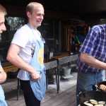 Photo by Kelly Sullivan/ Peninsula Clarion Jonas Vikstrom and Sebastian Gabriel watch Nels Anderson cut up a pork dish inside a Dutch oven, Saturday, July 19, in Soldotna.