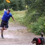 Photo by Dan Balmer/Peninsula Clarion Mike Miles from Anchorage unleashes a shot July 20 at the Kenai Eagle Frisbee Golf Course while his dog Nova enjoys a walk in the park. Miles, who visited the Kenai Peninsula last weekend, plays disc golf at Kincaid Park every week.