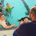 Photo by Kelly Sullivan/ Peninsula Clarion The lifeguard staff at the Nikiski Pool listens to Pool Supervisor Nigel Lariccia, June 30, at the Nikiski Pool.