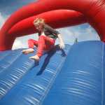 Photo by Rashah McChesney/Peninsula Clarion Makenna Dreyer, 9, jumps through an inflatable obstacle course set up by the Alaska Army National Guard Saturday July 26, 2014 during Soldotna Progress Days at the Soldotna Little League Fields.