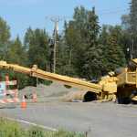 Photo by Rashah McChesney/Peninsula Clarion  An overturned crane sits in a ditch along Beaver Loop Road where Wednesday July 30, 2014 in Kenai, Alaska. Soldotna-based Endries Construction, the general contracter on a culvert replacement project along the road, was attemping to move a piece of the old culvert when the crane overturned according to the project engineer.