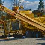 Photo by Rashah McChesney/Peninsula Clarion  Peter Endries walks next to an overturned crane at a jobsite on Beaver Loop Road Wednesday July 30, 2014 in Kenai, Alaska.