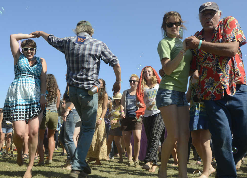 Photo by Rashah McChesney/Peninsula Clarion Jayme Carr hugs Meadow Carr, 6, as the two dance during a show at Salmonstock August 2, 2014 in Ninilchik, Alaska.