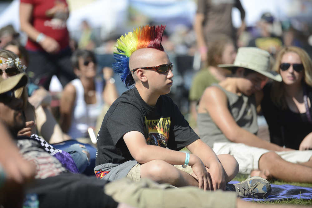 Photo by Rashah McChesney/Peninsula Clarion Jayme Carr hugs Meadow Carr, 6, as the two dance during a show at Salmonstock August 2, 2014 in Ninilchik, Alaska.