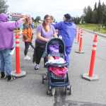 Photo by Kelly Sullivan/ Peninsula Clarion Michelle Teates pushed her 5-month-old daughter Hazel Teates for the entire Women's Run 10k, Saturday, August 9, 2014, at the Kenai Park Strip, Kenai, Alaska.