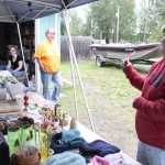 Photo by Kelly Sullivan/ Peninsula Clarion Traci Bicknell chats with her daughters, Miranda, 19, and Kelsey, 18, who helped out with the six-family garage sale held at Bicknell's mothers house, Saturday, August 9, 2014, in Soldotna, Alaska.