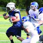 A Soldotna running back breaks a tackle in a scrimmage against Palmer Aug. 9 at the Chugiak Jamboree at Chugiak High School. The Stars travel to Palmer to face the Moose Aug. 22.