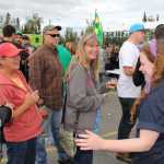 Photo by Dan Balmer/Peninsula Clarion Della McCarthy who works for the 49th State Brewing Company in Denali Park, talks about their beer selection to people waiting in line for a sample at the Kenai Peninsula Beer Festival Saturday in Soldonta. The brewery won the people's choice award for best beer for the 12-Quadruple, a dark Belgian ale with 10.5 percent alcohol that has notes of banana and caramel undertones. More than 15 breweries from all around the state participated in the festival, a fundraiser for the Rotary Club of Soldotna with benefits going to local rotary projects.