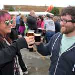 Photo by Dan Balmer/Peninsula Clarion Mandy Leslie of Anchorage beers with her brother Zack Leslie of Kenai at the Kenai Peninsula Beer Festival Saturday at the Soldotna Regional Sports Complex. Mandy Leslie said her favorite beer was the 12 Quadruple beer from the 49th State Brewing Company, which won as the people's choice for top beer. More than 15 breweries from all around the state participated in the festival, a fundraiser for the Rotary Club of Soldotna with benefits going to local rotary projects.