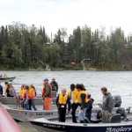 Logan Dawson, 9, waits in the fillet line with his silver salmon at the end of the Boys & Girls Clubs of the Kenai Peninsula and the Kenai River Foundation's Take Our Kids Fishing event on Thursday at Centennial Park in Soldotna. Photo by Kaylee Osowski