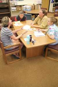 A group of Soldotna Prep teachers collaborate on Friday. Photo by Kaylee Osowski/Peninsula Clarion