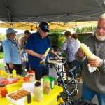 Photo by Kelly Sullivan/ Peninsula Clarion Community member Andy Paule prepares a corn husk during the Kenai Peninsula Borough, Kenai Peninsula College alumni and Kenai Peninsula Borough School District joint 50th anniversary community barbecue, Thursday, August 14, at the KPC Kenai River Campus in Soldotna, Alaska.