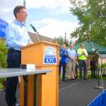 Photo by Kelly Sullivan/ Peninsula Clarion Kenai Peninsula Borough School District Superintendent Dr. Steve Atwater addresses the crowd of hundreds of Kenai Peninsula Borough officials, KPBSD staff, Kenai Peninsula College alumni and current students and staff, and community members at the joint 50th anniversary community barbecue, Thursday, August 14, at the KPC Kenai River Campus in Soldotna, Alaska.