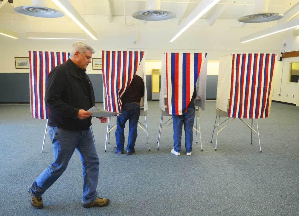 Photo by Kelly Sullivan/ Peninsula Clarion John Kennedy prepares to hand in his ballot at the Nikiski Recreation Center Tuesday, August 19, 2014, in Nikiski, Alaska.