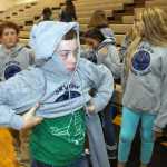 Photo by Kaylee Osowski/Peninsula Clarion New Kenai Central High School Assistant Principal Briana Randle tries to make a toilet paper dress on new teacher Ryan Moss as part of the new teacher initiation on the first day of the 2014-2015 school year at KCHS on Tuesday.