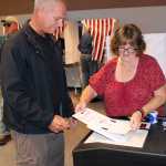 Photo by Dan Balmer/Peninsula Clarion Soldotna resident John Rysdyk turns in his ballot to Diane Hinshaw at the Soldotna City Hall Tuesday. After voting Rysdyk went to the grocery store to buy licorice and brought it back to the polling station for other voters to enjoy.