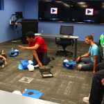 Photo by Kelly Sullivan/ Peninsula Clarion Keevin Macik walks Kenai Peninsula College's resident advisors through CPR training, Friday, August 8, 2014, at the Kenai Peninsula College in Soldotna, Alaska.