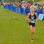 Photo by Jeff Helminiak Kenai Central senior Allie Ostrander finishes off a dominant win Saturday at the Tsalteshi Invitational at Tsalteshi Trails. Ostrander finished in 16 minutes, 44 seconds, to beat everybody else by more than two minutes.