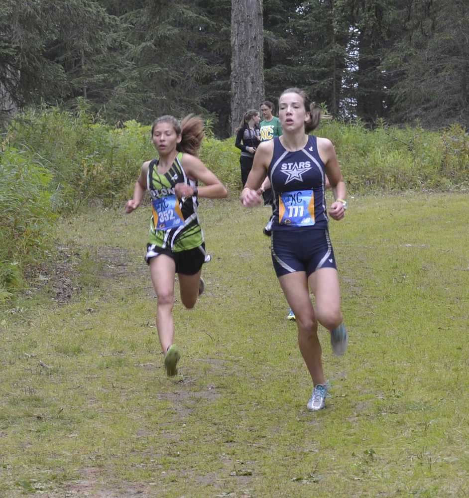 Photo by Jeff Helminiak Soldotna's Olivia Hutchings holds off Colony's Alex Mathis on a downhill Saturday at Tsalteshi Trails during the Tsalteshi Invite. Mathis would finish fourth, while Hutchings would take fifth.