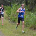 Photo by Jeff Helminiak Kenai Central's Jonah Theisen tries to hand on to Chugiak's Ty Jordan less than a kilometer from the finish Saturday at the Tsalteshi Invite at Tsalteshi Trails. Jordan would take second, while Theisen would be three seconds behind in third.