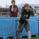 Gabe Brower, right, 13, of Kenai, retrieves a fishing buoy while his brother, Joel, 14, watches at the Kenai Peninsula Fishermen's Association booth at Industry Appreciation Day in Kenai.