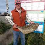Andrew VanderPlaat of Pendleton, Oregon, onboard DeepStrike Sportfishing's Grand Aleutian with Captain David Bayes, won $500 when he caught a 12.6 pound tagged halibut. (Photo courtesy Homer Chamber of Commerce)