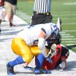 Photo by Kelly Sullivan/ Peninsula Clarion Kodiak High School's Elijah Squartsoff tackles Kenai Kardinal's Chase Gillies, Saturday, August 30, 2014 during the varsity game at Kenai Central High School in Kenai, Alaska.