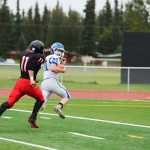 Photo by Kelly Sullivan/ Peninsula Clarion Kenai Central High School Kardinal's Number 40 Kyle Foree attempts to tackle, Palmer High School's Number 20 Tom Adams or Number 20 Chase Ferris, Friday, August 6, 2014, at Kenai Central High School in Kenai Alaska.