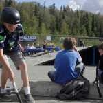 Photo by Rashah McChesney/Peninsula Clarion  Brady Baker grabs his scooter and takes off during a the BMX biking competition portion of the 5th Annual Bike & Skate Challenge Saturday Sept. 6, 2014 iat the Soldotna Skate Park in Soldotna, Alaska.