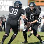 Photo by Kelly Sullivan/ Peninsula Clarion Dennis Anderson passes subtly passes the ball to Dylan Brousard during a game against the Eielson Ravens, Saturday, September 6, 2014, at Nikiski High School in Nikiski, Alaska.