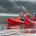 In this July, 2013, photo, from left, Robin Hanley, Bjorn Dihle, Lynnette Dihle and Nils Dihle watch bears on the shore of Middle Creek on Admiralty Island near Windfall Harbor, Alaska.  The area around Pack Creek, a bear-viewing area on Admiralty Island, offers some amazing sights not too far from Juneau, Alaska.(AP Photo/Juneau Empire, Mary Catharine Martin)